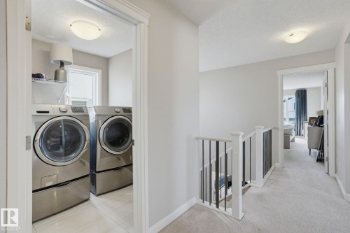Dedicated laundry area with tile flooring and a window - 9448 228 Street Nw, Edmonton, AB 
