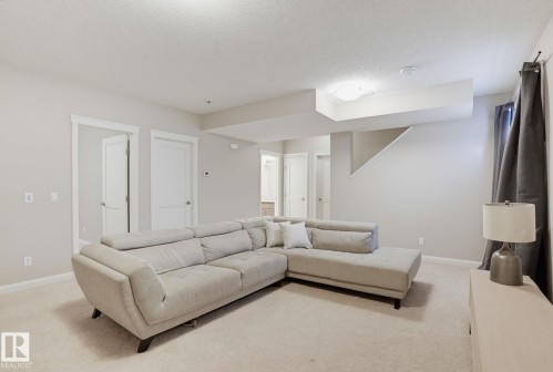 Recessed lighting and a flush mount ceiling fixture illuminate the space - 9448 228 Street Nw, Edmonton, AB 