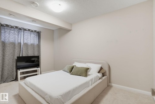 Neutral wall color, carpeted flooring, built-in ceiling light, and window with textile coverings - 9448 228 Street Nw, Edmonton, AB 