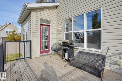 Outdoor wood-finish deck with black metal railing - 9448 228 Street Nw, Edmonton, AB 