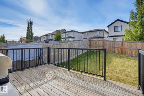 Expansive wood deck with black metal railings - 9448 228 Street Nw, Edmonton, AB 