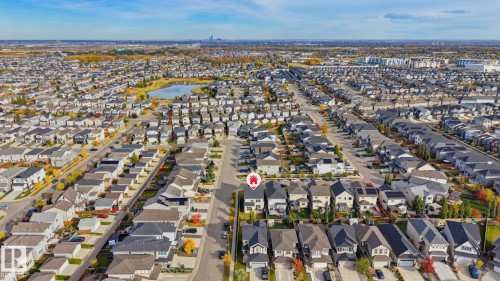 Aerial perspective of a residential community with a central water feature - 9448 228 Street Nw, Edmonton, AB 