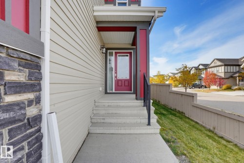 Cream-colored siding exterior with a stone accent facade - 9448 228 Street Nw, Edmonton, AB 