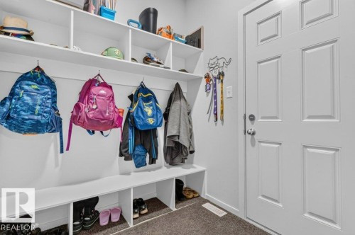 Built-in white shelving unit with integrated bench seating and individual storage cubbies - 1020 Daniels Loop Sw, Edmonton, AB 