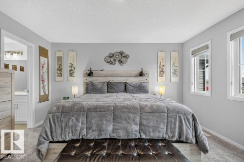 Two bright windows, light gray wall paint, and gray carpeted flooring - 1020 Daniels Loop Sw, Edmonton, AB 