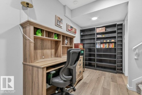 Dedicated workspace featuring wood-finish flooring, built-in shelving, and recessed lighting - 1020 Daniels Loop Sw, Edmonton, AB 