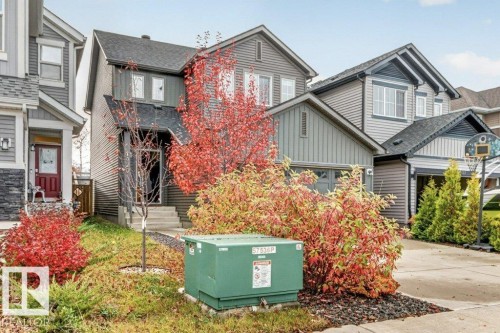 Two-story exterior with dark gray siding, prominent gable roof, and an attached front-facing garage - 1020 Daniels Loop Sw, Edmonton, AB 
