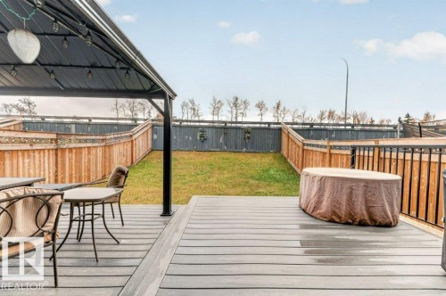 Spacious outdoor deck with composite decking, black metal railing, and a covered gazebo - 1020 Daniels Loop Sw, Edmonton, AB 