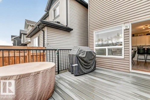 Spacious outdoor deck with composite decking and black metal railings - 1020 Daniels Loop Sw, Edmonton, AB 