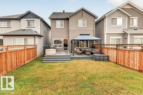 Expansive backyard featuring a manicured lawn, a multi-level deck, and a built-in gazebo - 1020 Daniels Loop Sw, Edmonton, AB 