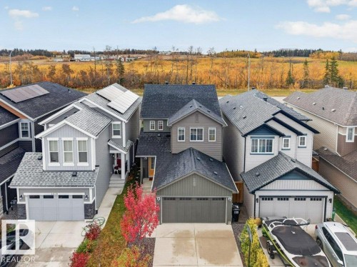 Contemporary two-story residence featuring a two-car garage, concrete driveway, and a gabled roof - 1020 Daniels Loop Sw, Edmonton, AB 
