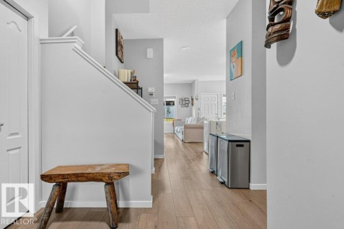Wood-finish flooring, light grey wall paint, and white trim - 1020 Daniels Loop Sw, Edmonton, AB 