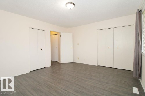 White bathtub with a chrome faucet and showerhead - 11393 22 Avenue Nw, Edmonton, AB 