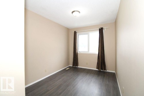 Unfinished basement with concrete flooring and exposed ceiling joists - 11393 22 Avenue Nw, Edmonton, AB 