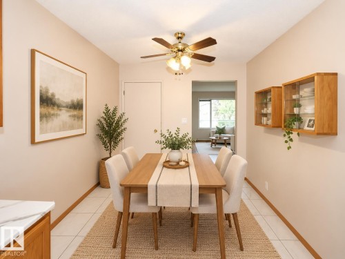 Kitchen featuring wood-finish cabinetry, white tile flooring, ceiling fan, and built-in appliances - 11393 22 Avenue Nw, Edmonton, AB 
