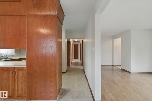 Wood-finish cabinetry, white countertops, and wood-finish flooring - 8424 70 Street Nw, Edmonton, AB 