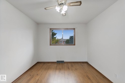 Wood-finish flooring, white walls, and a ceiling fan with integrated lighting - 8424 70 Street Nw, Edmonton, AB 