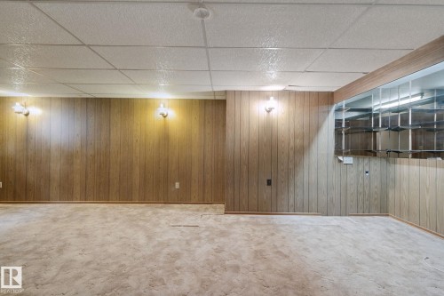 Recessed lighting, wood paneling, wall sconces, drop ceiling, and carpeted flooring - 8424 70 Street Nw, Edmonton, AB 