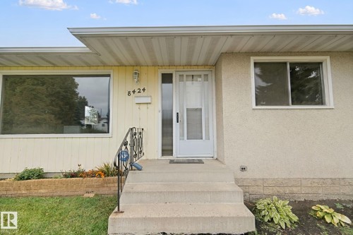 Concrete front steps with wrought iron railing - 8424 70 Street Nw, Edmonton, AB 