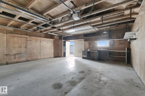 Concrete flooring with exposed ceiling beams and structural elements - 8424 70 Street Nw, Edmonton, AB 