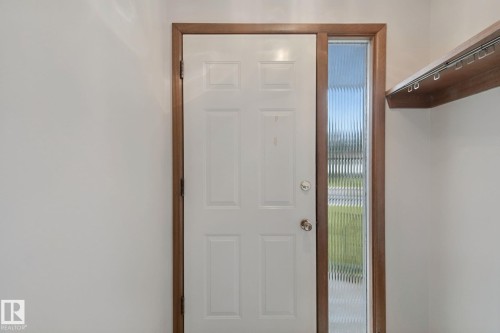 White paneled entry door with wood-finish trim - 8424 70 Street Nw, Edmonton, AB 