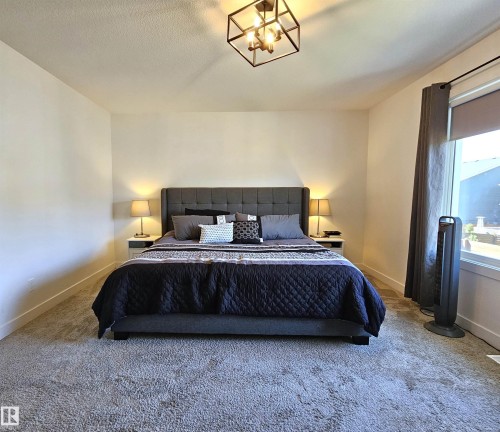 Recessed lighting, wall-to-wall carpeting, and a window with roller shade - 40 Jamison Crescent, St. Albert, AB 