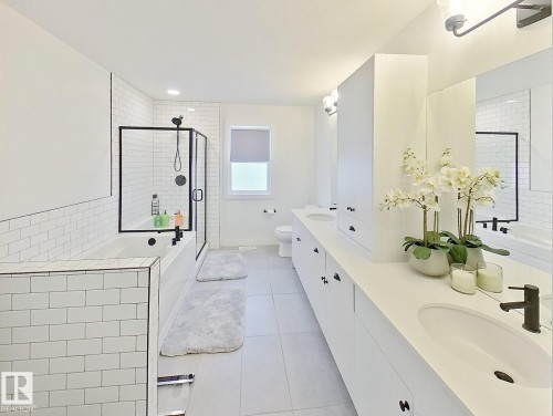 Dual vanity with integrated sinks, extensive countertop space, white cabinetry, and matte black fixtures - 40 Jamison Crescent, St. Albert, AB 