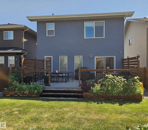 Rear exterior featuring blue horizontal siding and multiple windows - 40 Jamison Crescent, St. Albert, AB 