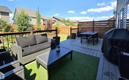 Expansive multi-level deck featuring composite decking, wood privacy screen, and artificial turf accent - 40 Jamison Crescent, St. Albert, AB 
