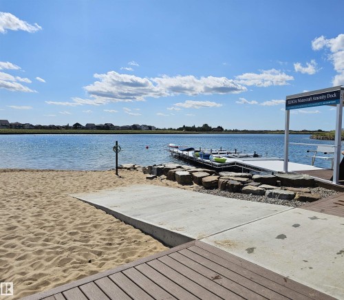 Waterfront access featuring a sandy beach, concrete ramp, and a multi-slip dock with a watercraft amenity - 40 Jamison Crescent, St. Albert, AB 
