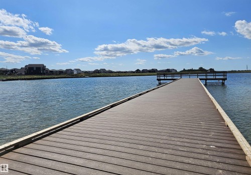 Waterfront property featuring a composite deck pier, access to a body of water, and surrounding residential structures - 40 Jamison Crescent, St. Albert, AB 