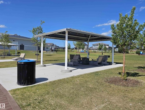 Shaded communal area featuring a covered structure, concrete paving, and surrounding green space - 40 Jamison Crescent, St. Albert, AB 