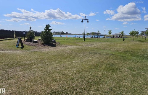 Expansive open green space with scattered trees and a distant body of water - 40 Jamison Crescent, St. Albert, AB 