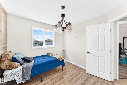 Wood-finish flooring with a white trim - 447 Songhurst Place, Leduc, AB 