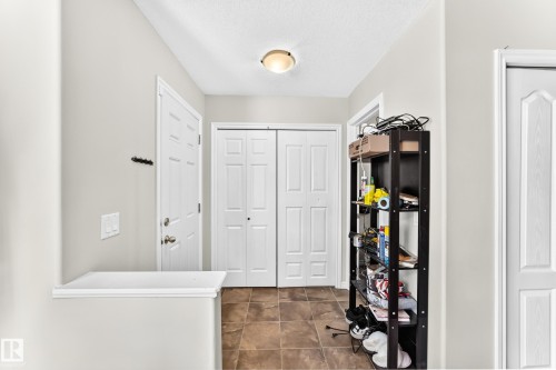 Tiled flooring, overhead flush-mount lighting, and white paneled doors - 447 Songhurst Place, Leduc, AB 