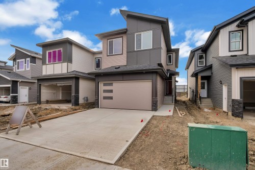 Modern exterior with clean lines, mixed siding, and stone accents - 178 Munn Way, Leduc, AB 