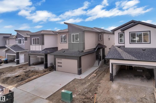 Contemporary architecture featuring multiple rooflines, attached garages, and concrete driveways - 178 Munn Way, Leduc, AB 