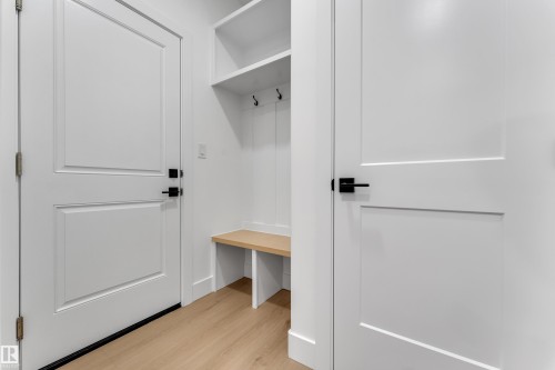 Built-in storage bench with shelving and coat hooks - 178 Munn Way, Leduc, AB 