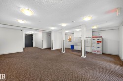 Mailroom with multiple individual mailboxes, overhead lighting, and carpeted flooring - 
