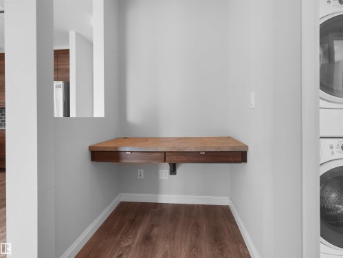 Built-in wood-finish desk with integrated drawers - #415 2588 Anderson Wy Sw, Edmonton, AB 