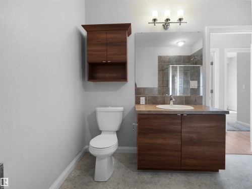Wood-finish vanity with an integrated sink and countertop - #415 2588 Anderson Wy Sw, Edmonton, AB 