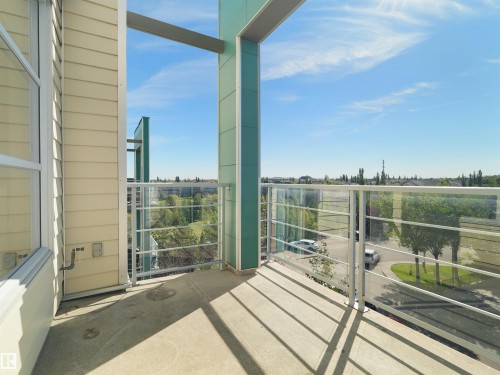Concrete balcony with glass and metal railing - #415 2588 Anderson Wy Sw, Edmonton, AB 
