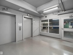 Two elevators with brushed metal call buttons - 