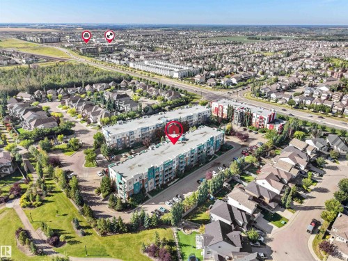 Aerial perspective of a multi-unit residential building featuring a flat roof and multiple balconies - #415 2588 Anderson Wy Sw, Edmonton, AB 
