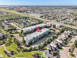 Aerial perspective of a multi-unit residential building featuring a flat roof and multiple balconies - 