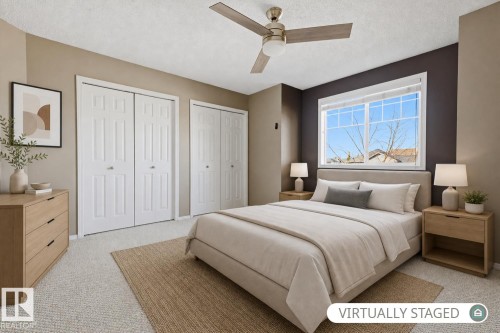 Neutral interior space featuring dual-panel closet doors, a ceiling fan with integrated lighting, a sliding window, and accent wall paint - 9047 Scott Crescent Nw, Edmonton, AB 
