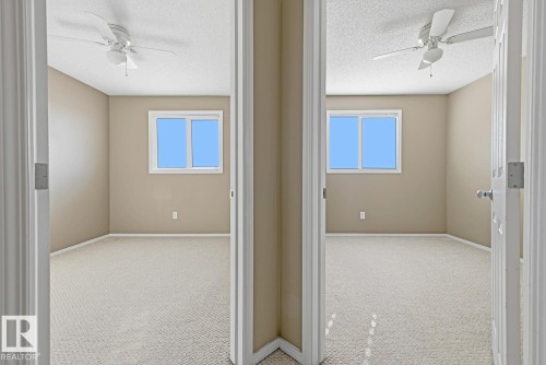 Neutral-toned rooms featuring carpeting, ceiling fans with integrated lighting, and dual-pane windows - 9047 Scott Crescent Nw, Edmonton, AB 