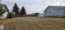 Expansive lot with partial wood fencing and partial white vinyl fencing - 5613 45A Street, Vegreville, AB 