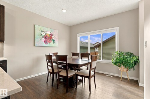 Recessed ceiling lighting, wood-finish flooring, white trim, and a large window - 21935 91 Avenue Nw, Edmonton, AB 
