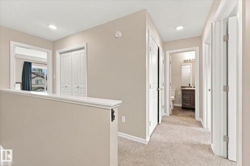 Plush carpeted hallway with recessed lighting - 21935 91 Avenue Nw, Edmonton, AB 